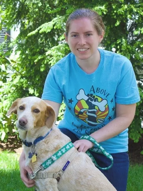 A woman holding a dog in her arms.