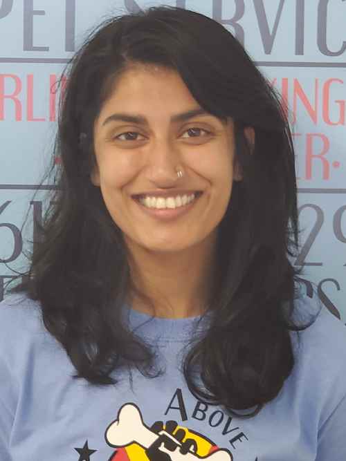 A woman with long hair smiles for the camera.