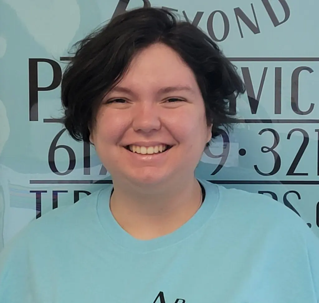 A woman standing in front of a wall with the word " abc ".