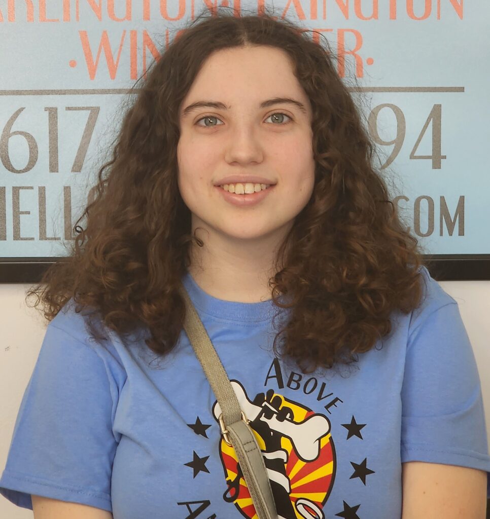 A woman with long hair and a blue shirt.