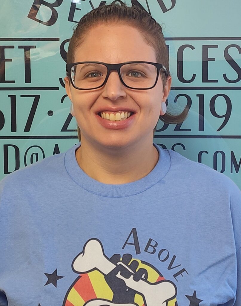 A woman wearing glasses and smiling for the camera.