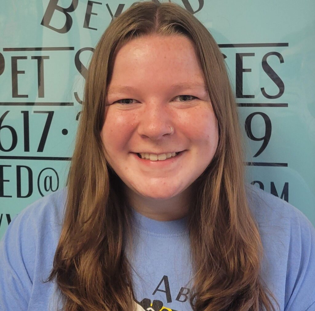 A girl with long hair smiles for the camera.