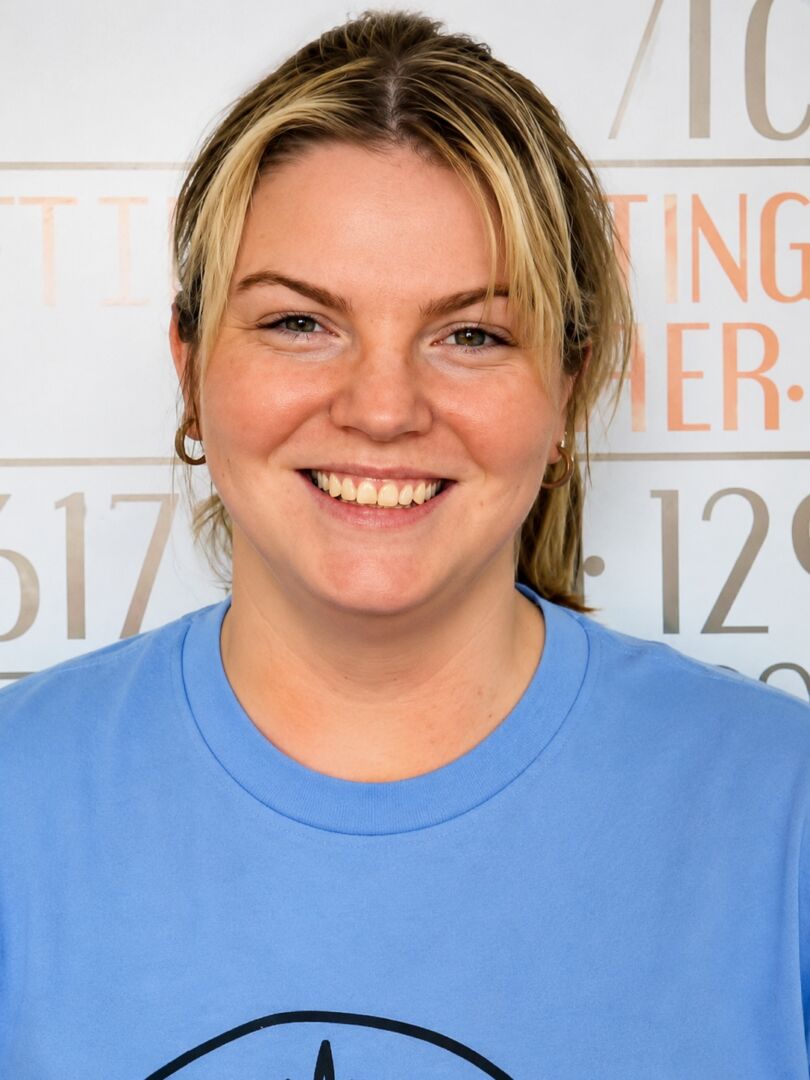 Cheerful employee wearing a blue t-shirt.