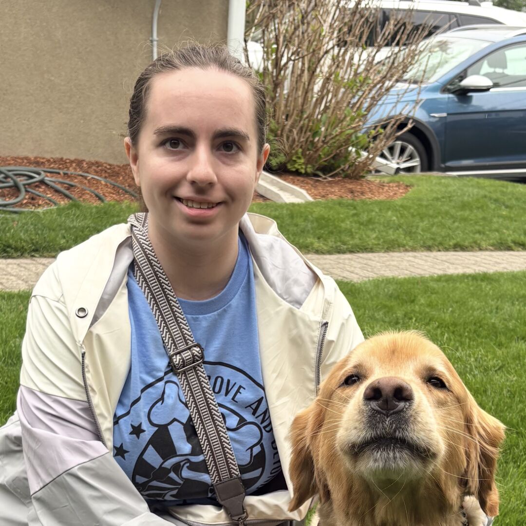 Employee portrait with a golden retriever.